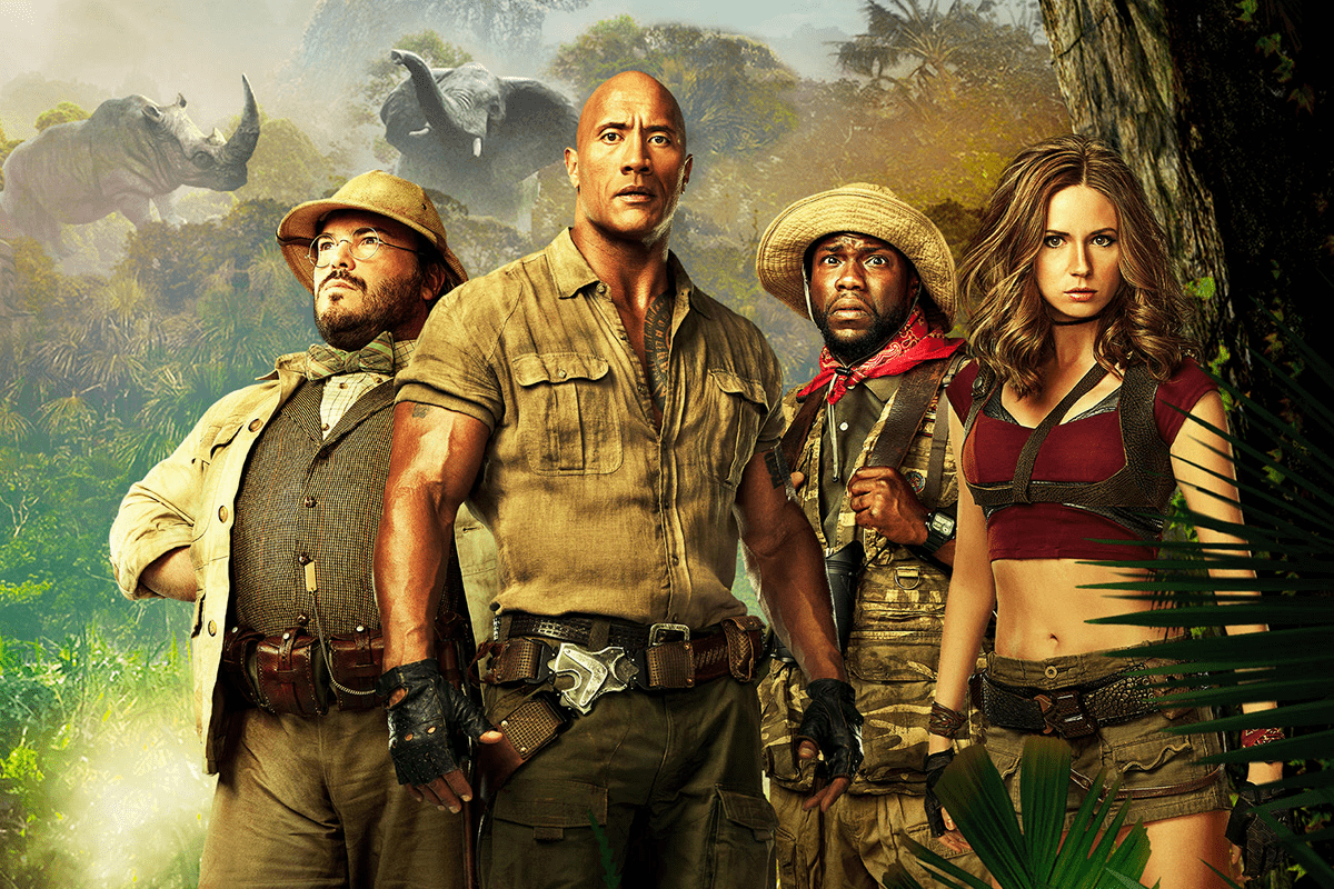 Four adventurers stand confidently; one holds an intense stare. Dense jungle surrounds them with an elephant and rhinos in the background.