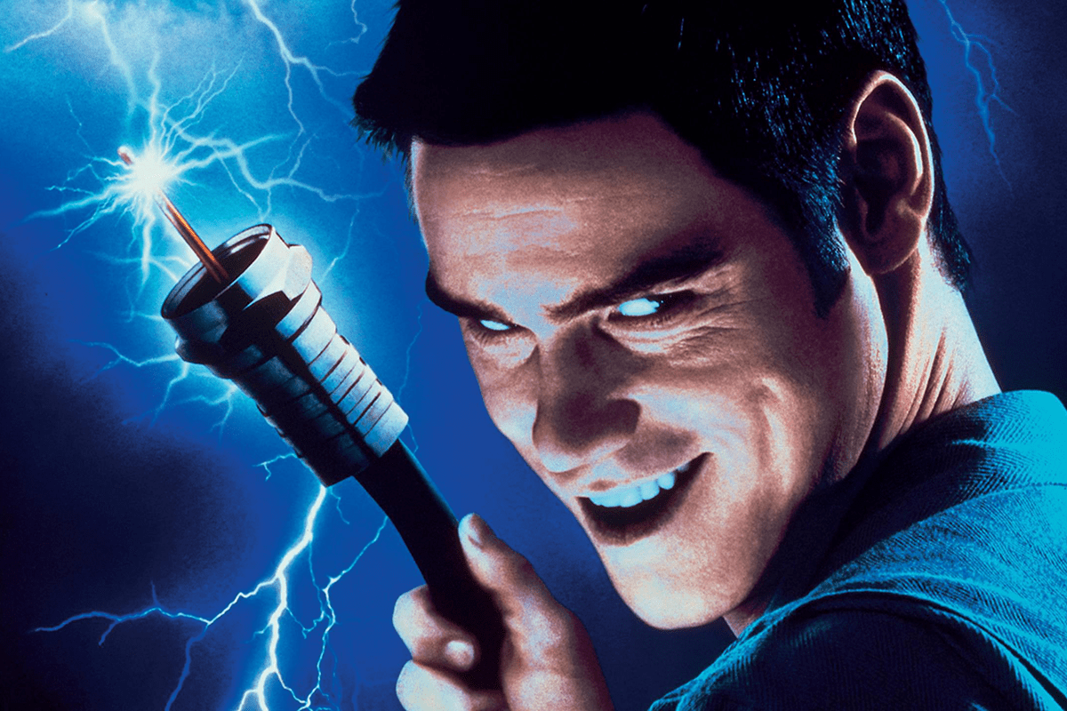 A person holds a sparking cable against a blue, electrified background, grinning mischievously.
