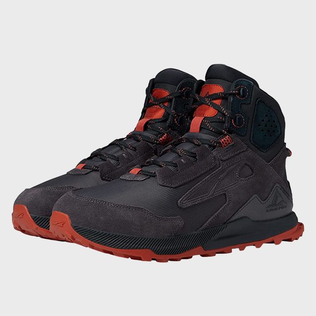 Black hiking boots with red soles and laces, positioned against a plain white background.