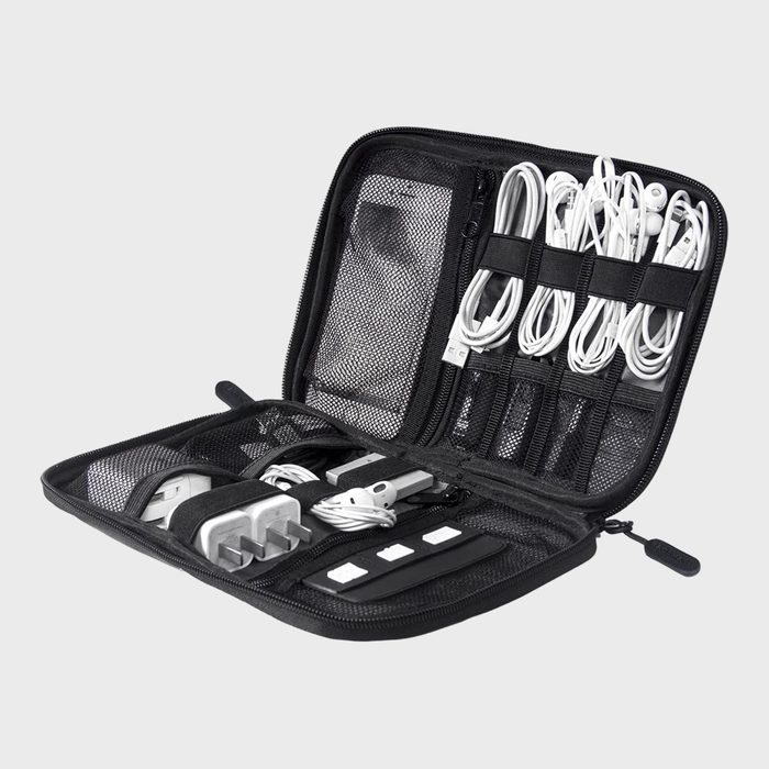 A black zippered organizer holds neatly arranged electronic cables and plugs, with mesh pockets and elastic bands, against a plain background.