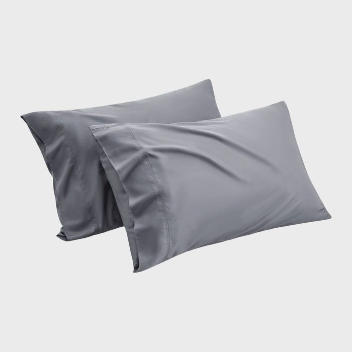 Two gray pillowcases lie neatly folded, arranged against a plain white background.