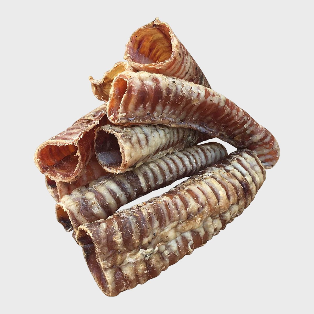 Dried, ribbed hollow tubes are stacked together, placed against a plain white background.