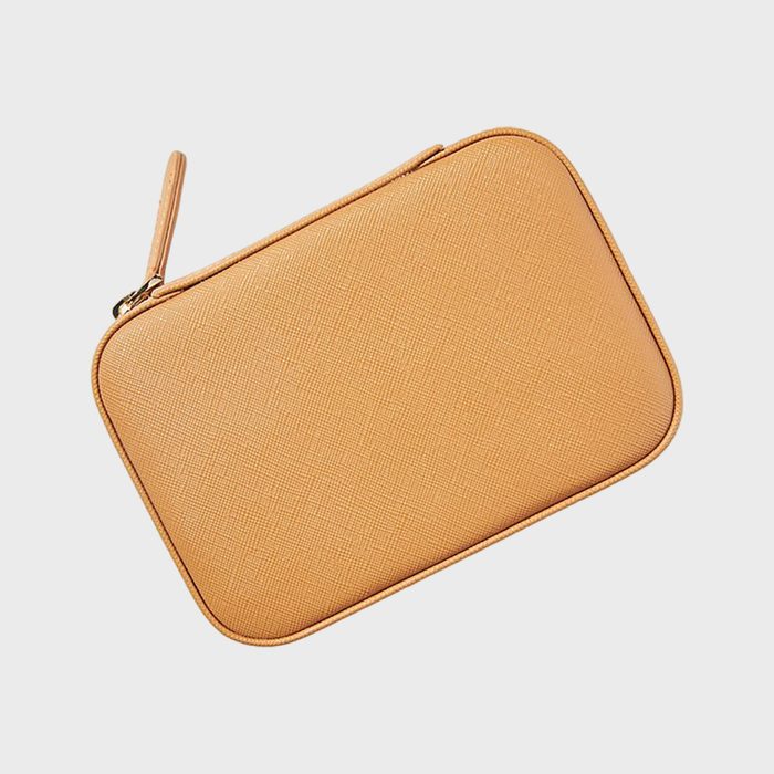 A tan, rectangular pouch with a zipper lays on a light background.