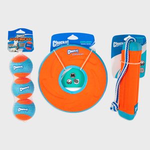 Dog toys are packaged; orange and blue balls, a frisbee, and a floatation stick, all labeled 