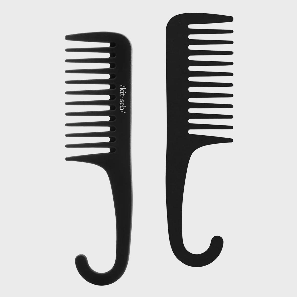 Two black wide-tooth combs with hook handles, positioned vertically on a white background. One has text "/kits.ÊŒh/" on the handle.