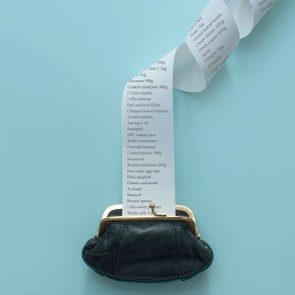 Purse opens on blue surface, releasing a lengthy shopping list cascading down, detailing various groceries like apples, potatoes, and orange juice.
