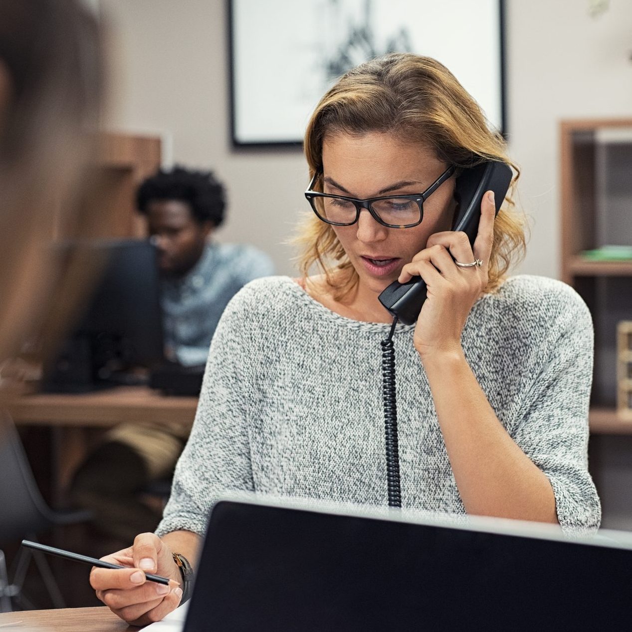 Businesswoman talking on phone at office