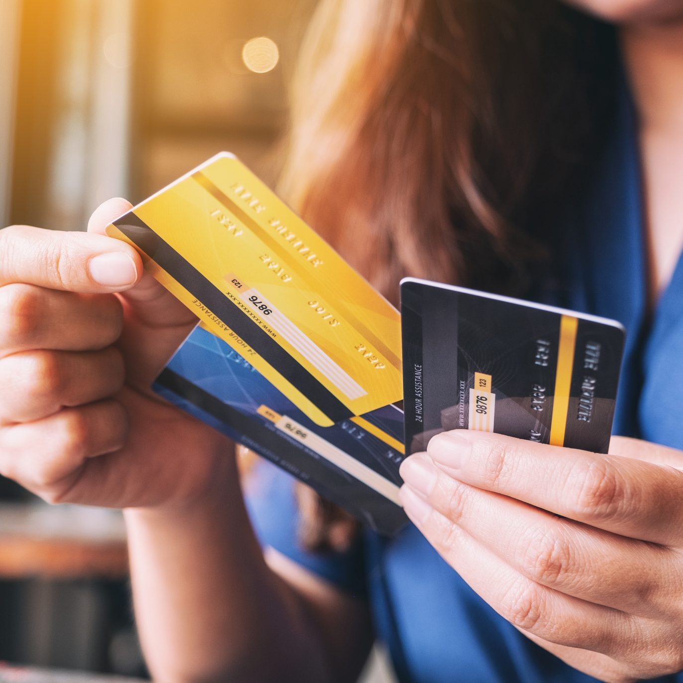 a woman holding and choosing credit card to use