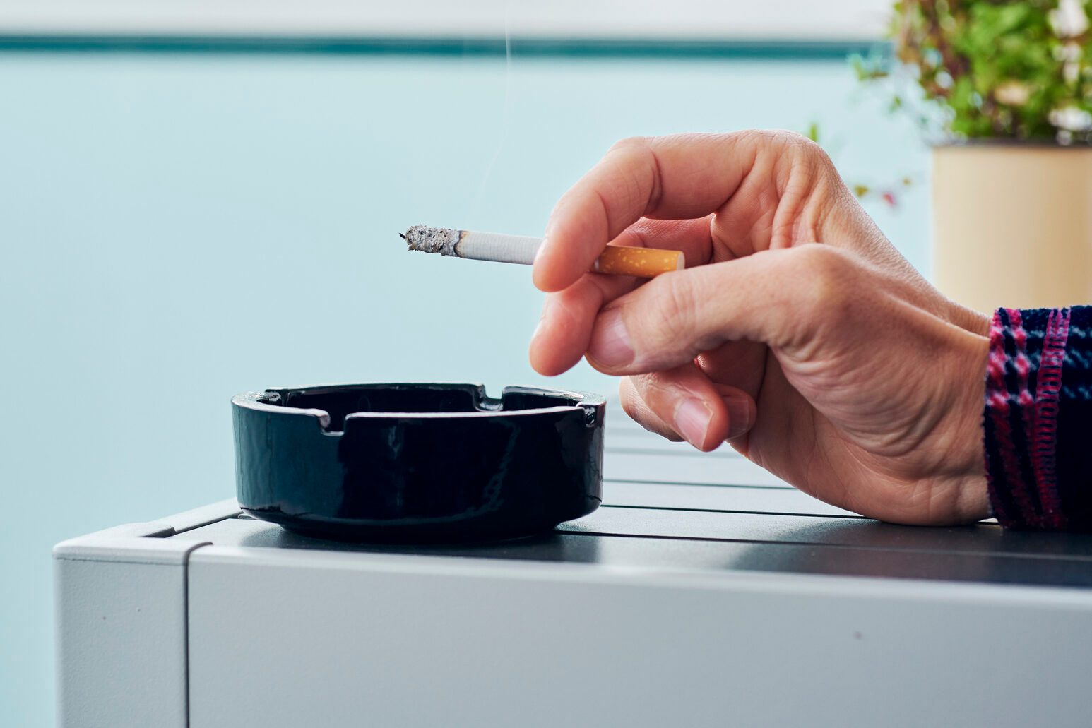 man in pajamas smoking in the balcony