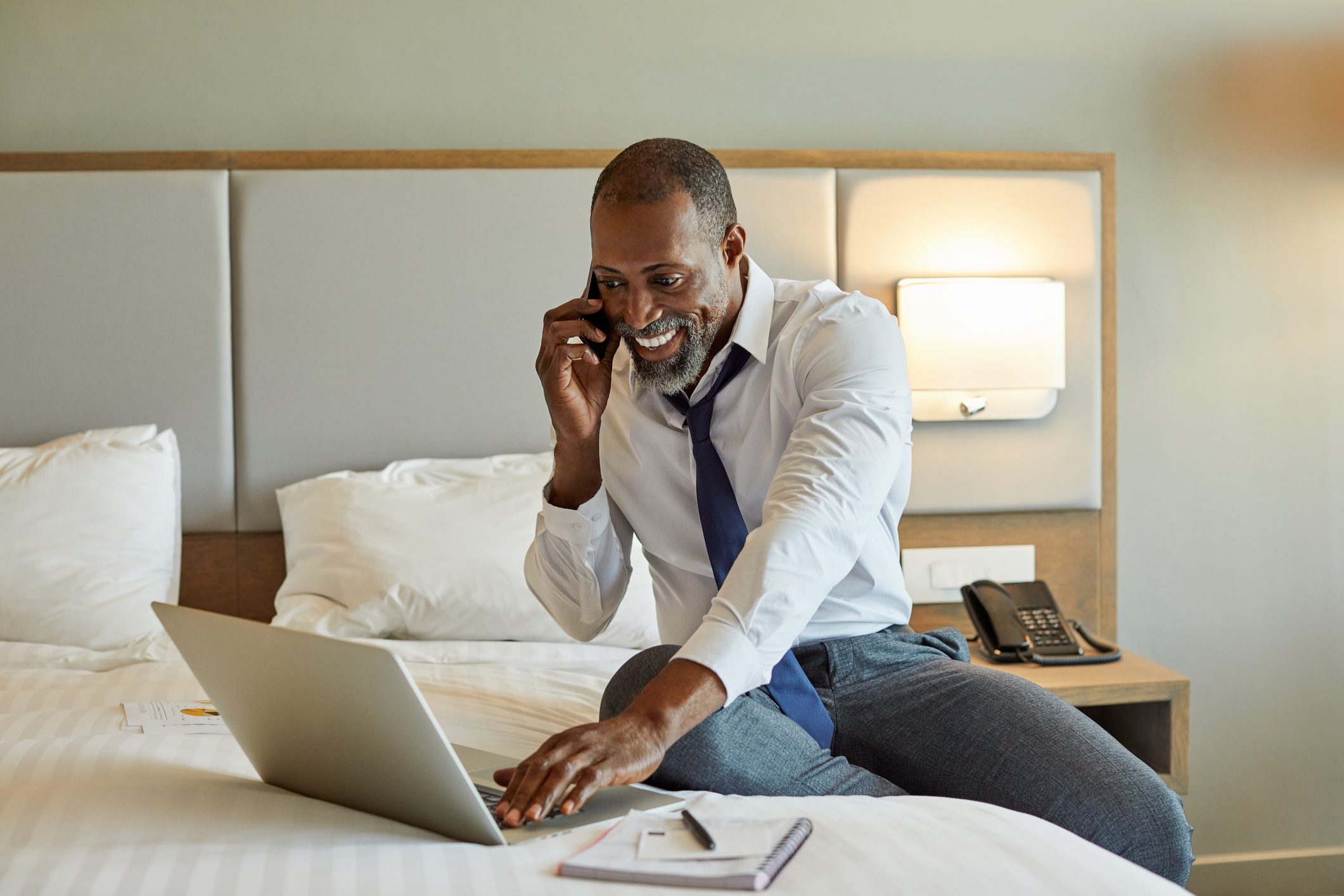 Businessman working while using laptop in hotel