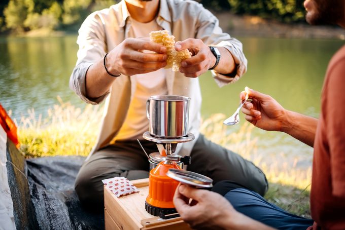 Two campers preparing lunch on a camping trip