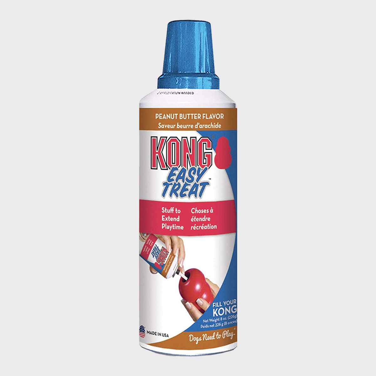 A canister holds peanut butter-flavored treat, designed for filling dog toys, with a blue cap and colorful label advertising "KONG Easy Treat."