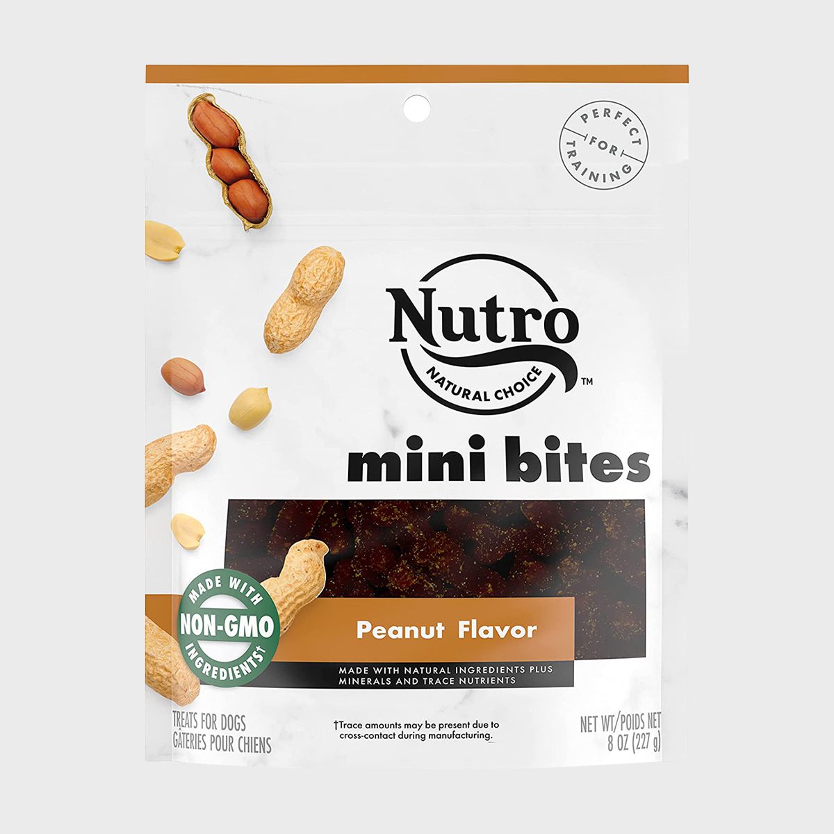 Bag displaying Nutro mini bites with peanuts and text highlighting "Non-GMO Ingredients" and "Peanut Flavor." Designed for training context, treats for dogs.