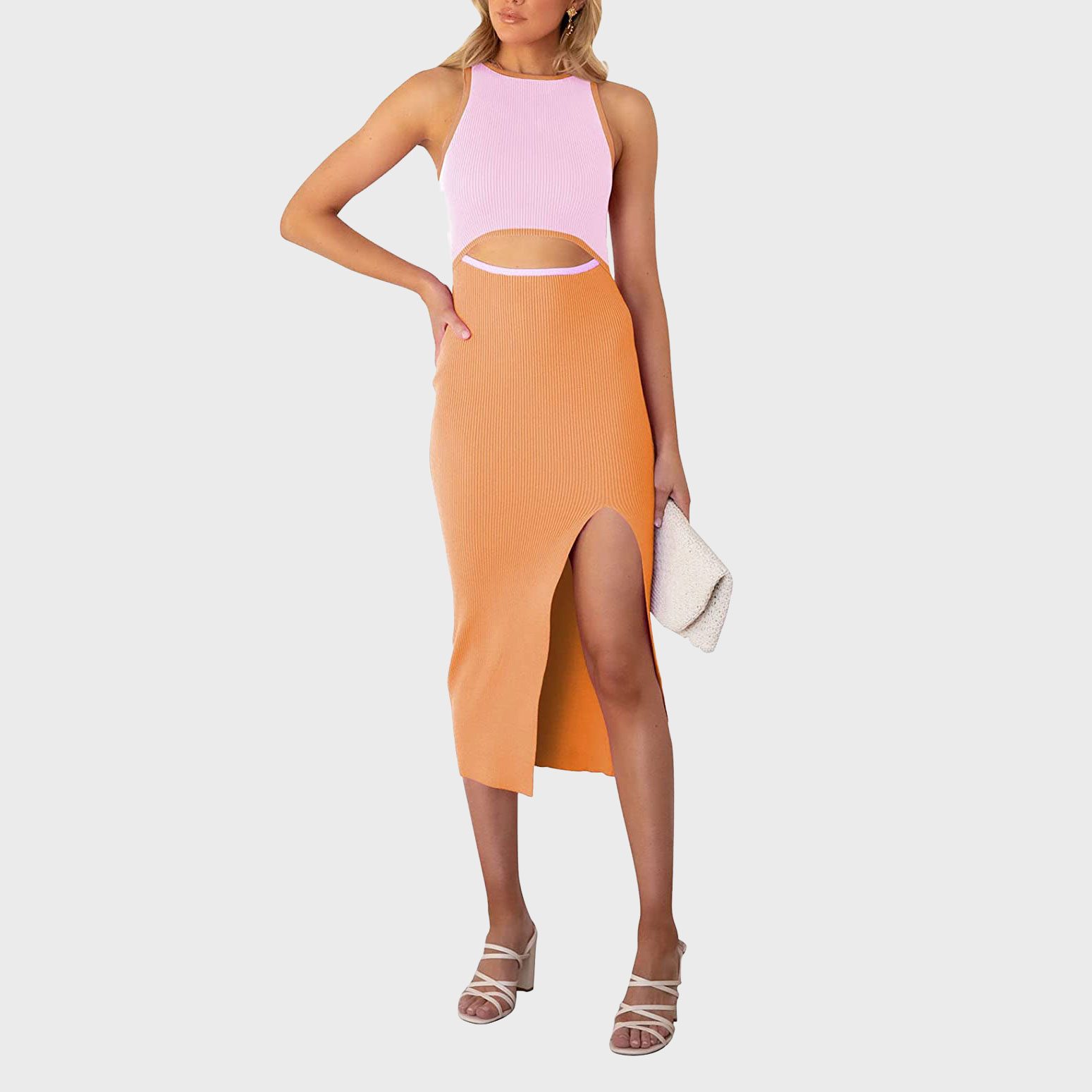 Woman poses wearing a pink and orange dress, holding a beige clutch. She stands on a plain white background, showcasing strappy white heels.