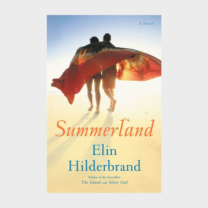 Two people walk on a beach wrapped in a red blanket, creating a silhouette against a bright sky. Text: 