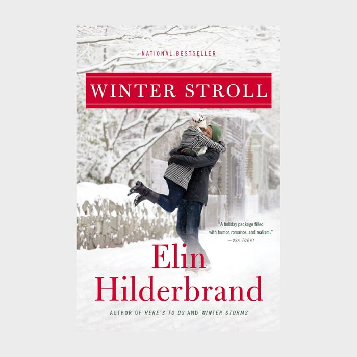 Couple embraces joyfully, standing amid snow-covered trees. The book 