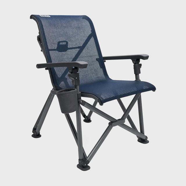 Chair resting on a flat surface, has a mesh back, foldable frame, armrests, and attached cup holder, surrounded by a plain, white background.