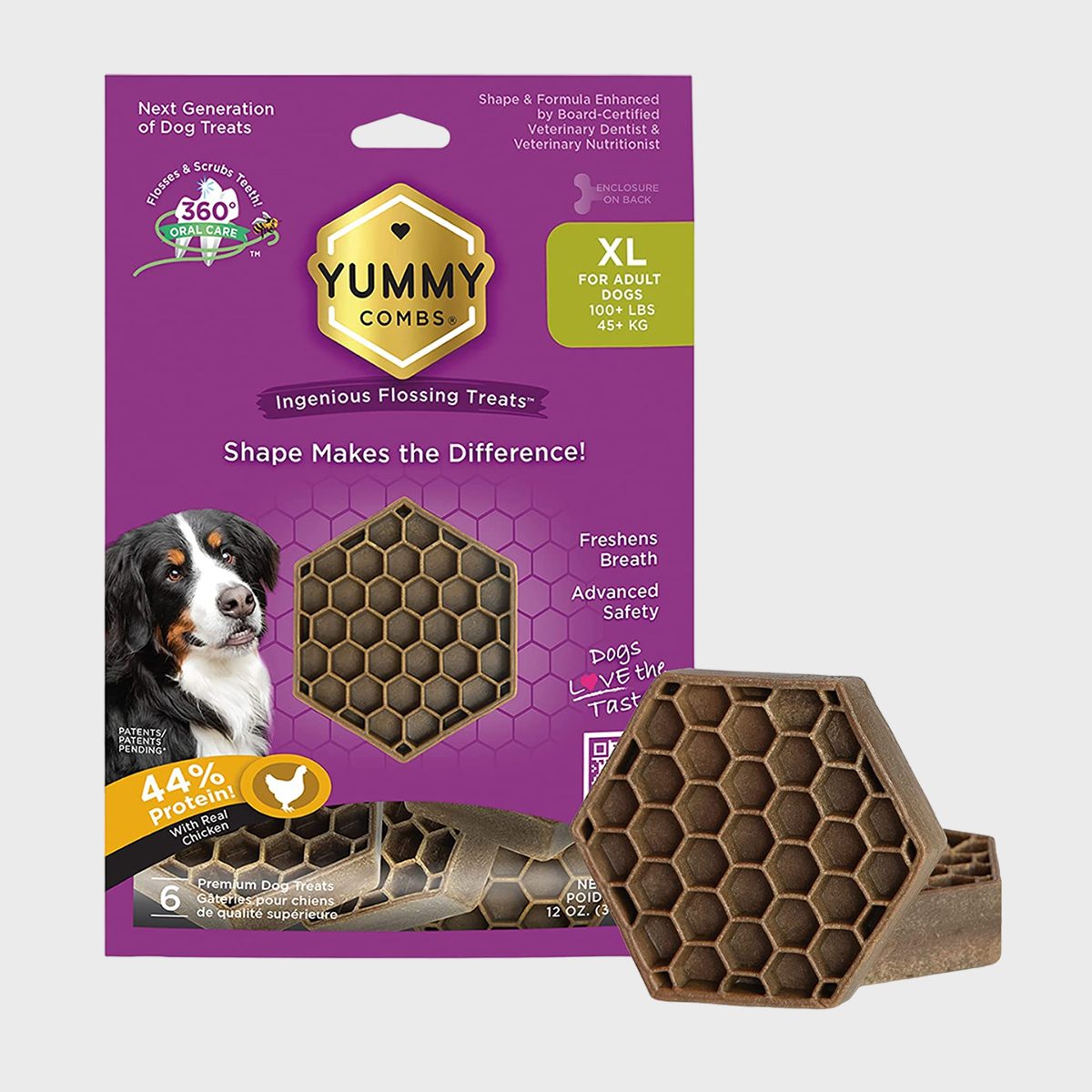 Dog treat displayed with hexagonal shape, promoting dental health. Purple packaging features a dog image, highlighting benefits like breath freshening and protein content. Text: "Yummy Combs."