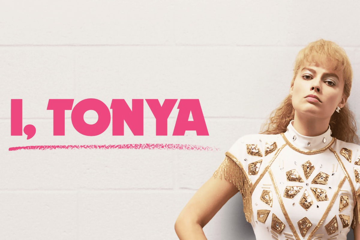A woman poses confidently in an embellished outfit; text reads "I, TONYA" in bold pink against a light-colored wall.