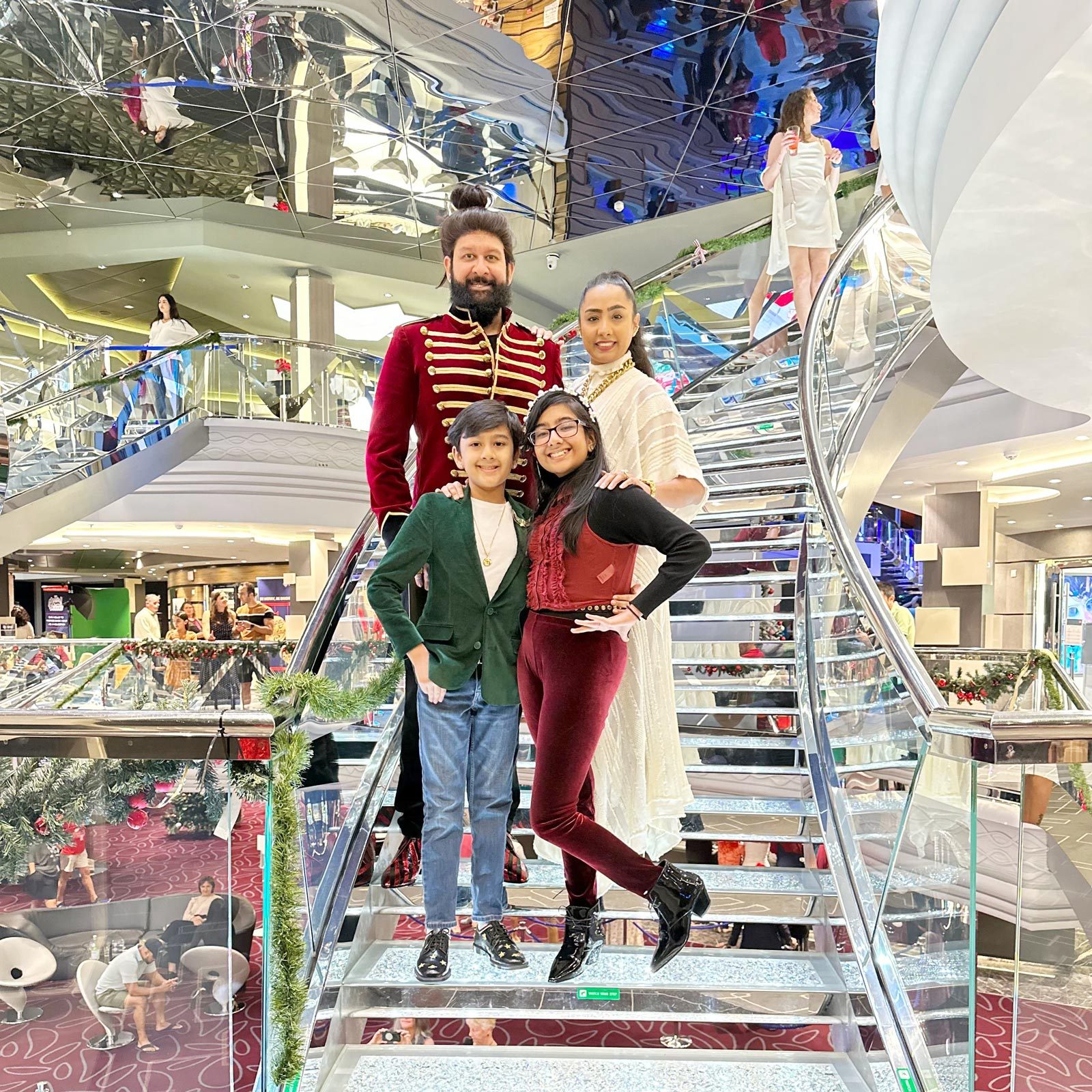 family of five posing for a picture on cruise stairs