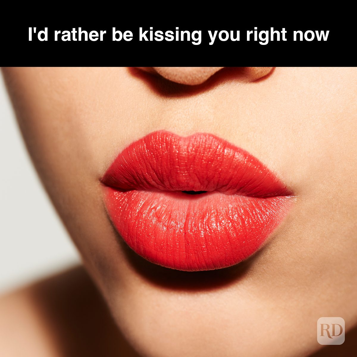 Red lips are slightly puckered against a neutral background. Text above reads, "I'd rather be kissing you right now."
