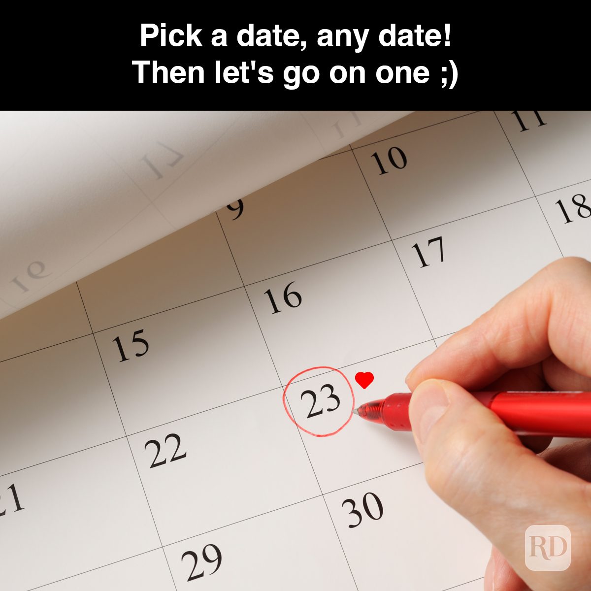 Hand circles calendar date 23 with red pen; heart added. Text above: "Pick a date, any date! Then let's go on one ;)".