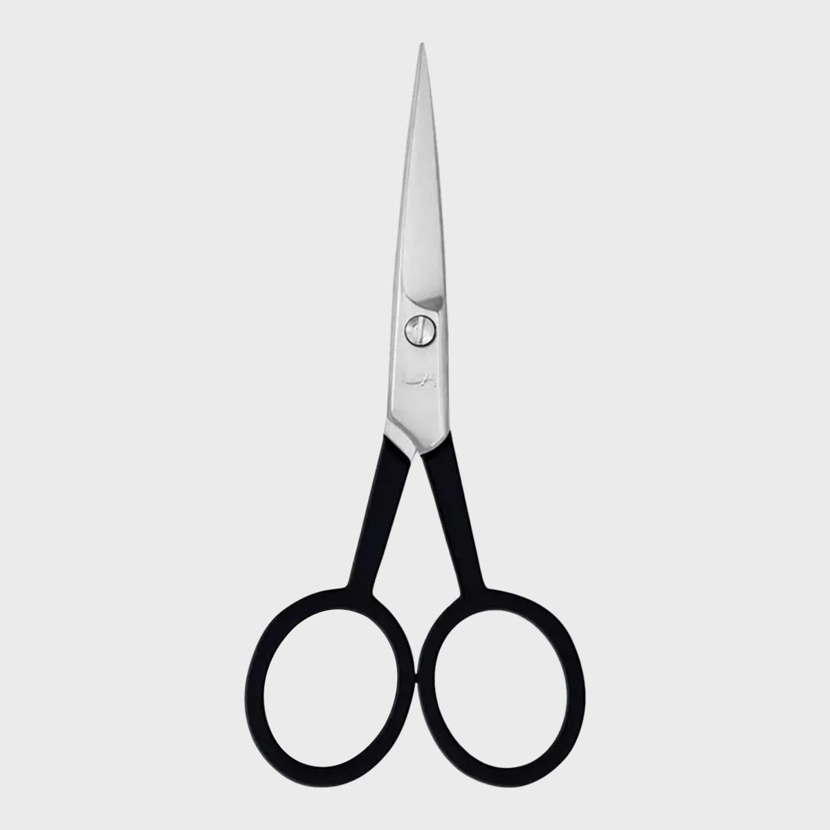 Scissors resting on a plain surface, featuring black handles and sharp, silver blades, arranged in a symmetrical, open position.