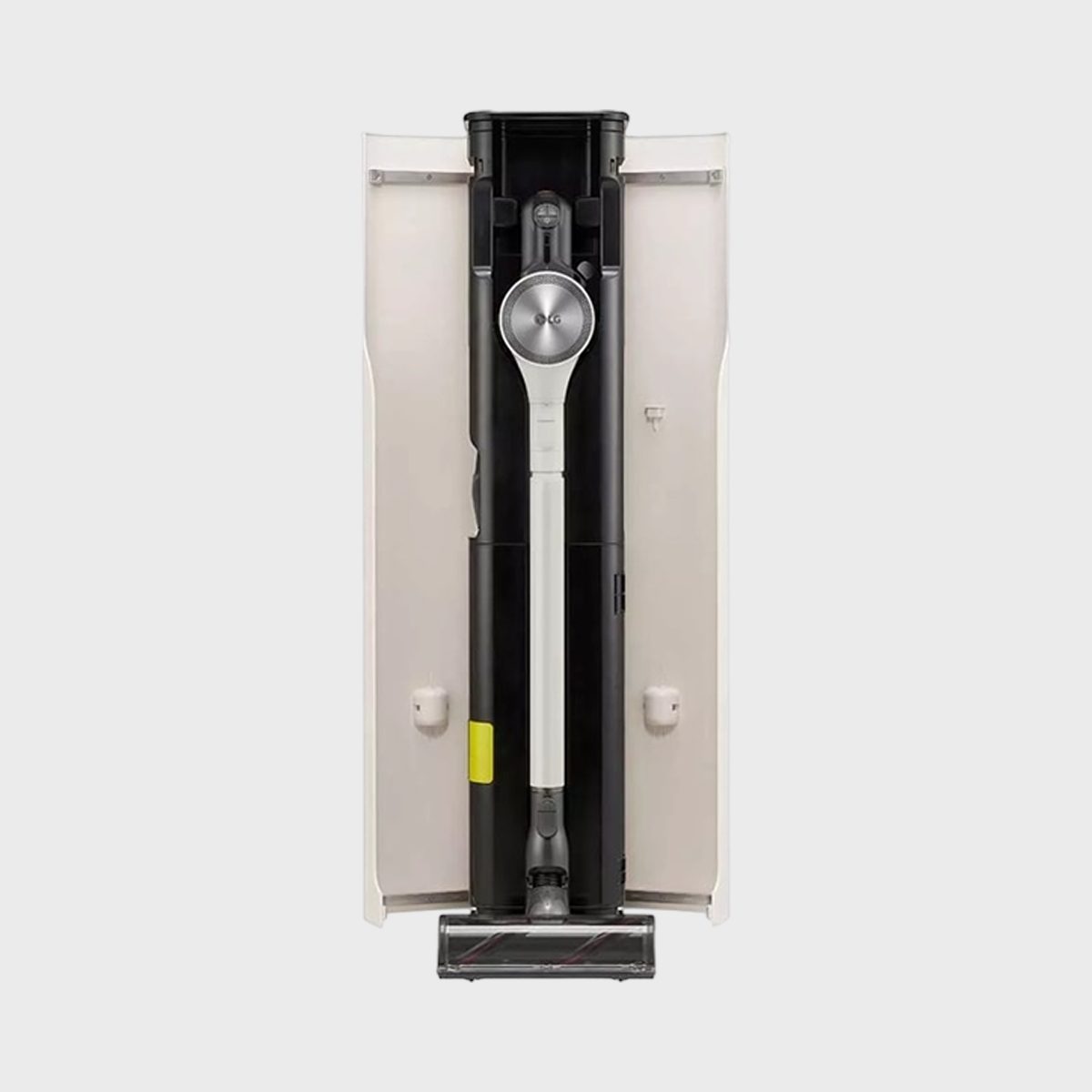 Vacuum cleaner stored upright inside a sleek, open vertical docking station, surrounded by a light neutral background.