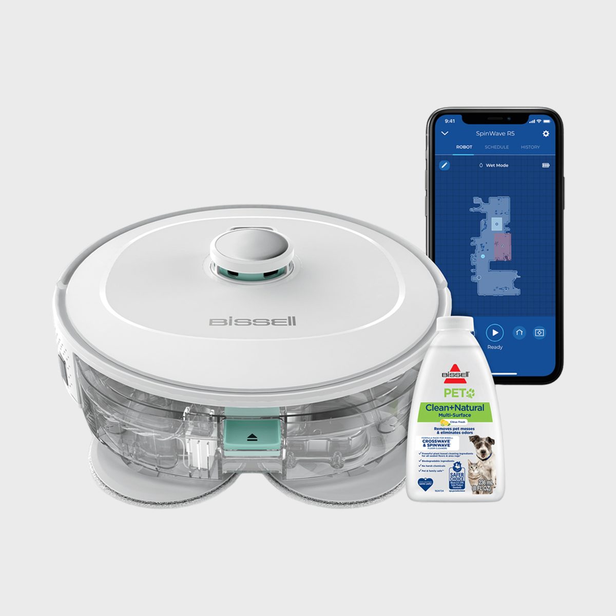 Robot vacuum sits beside a smartphone displaying a cleaning app and a bottle of cleaning solution, set against a plain background.
