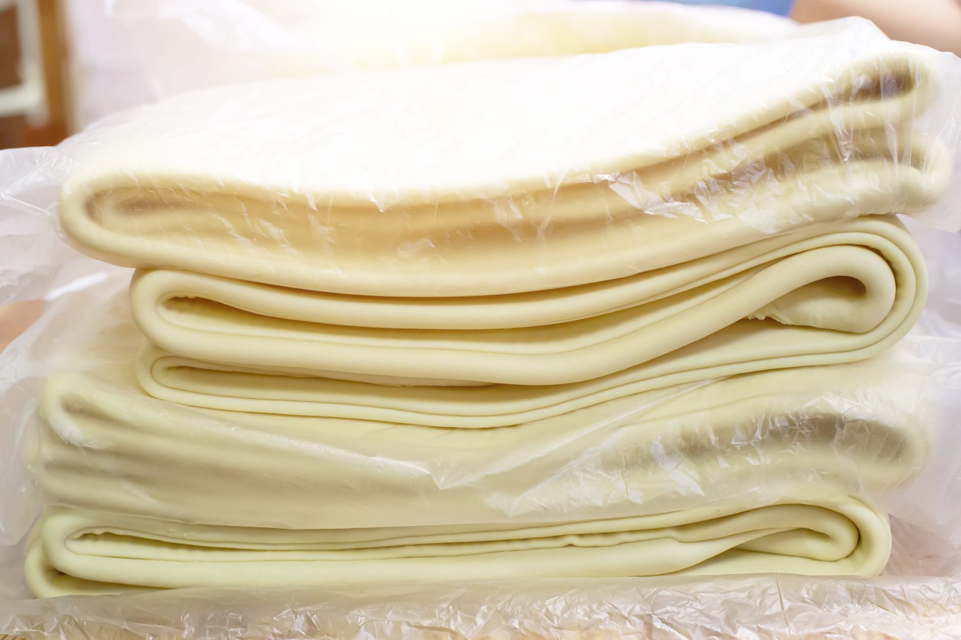 A lot of puff pastry in a baking factory for making puff pastries, production pizza