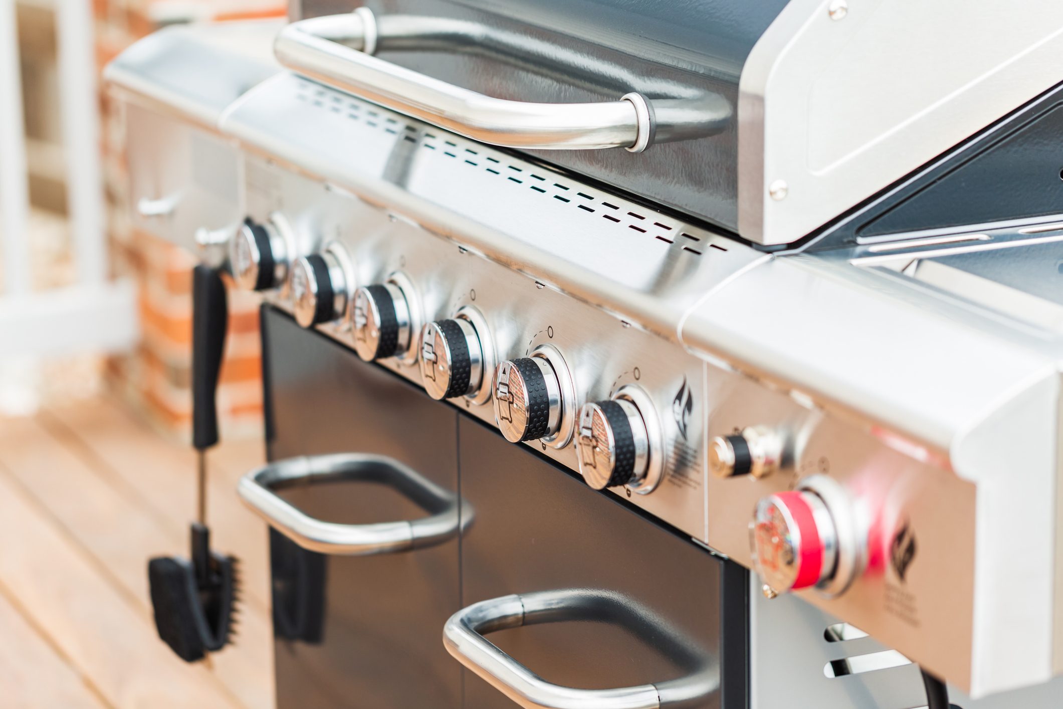 Close up of control knobs on outdoor 6 burner gas grill.