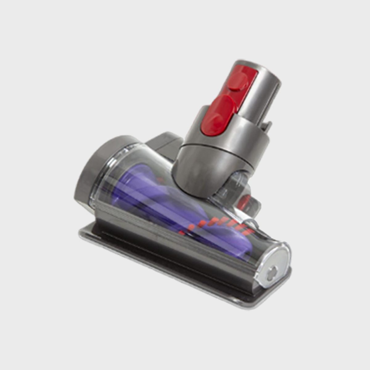 Vacuum nozzle rests on a flat white surface, featuring red buttons and a transparent casing revealing purple and red components inside.