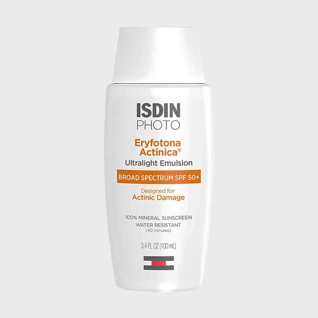 A white bottle displays sunscreen details; it's labeled broad spectrum SPF 50+, designed for actinic damage, with mineral and water-resistant properties.
