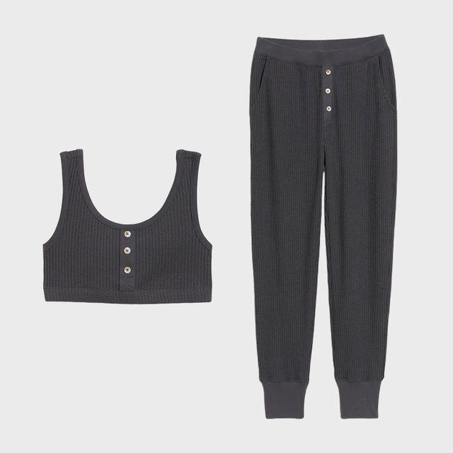 Dark gray ribbed top and pants with buttons; resting on a plain white background.