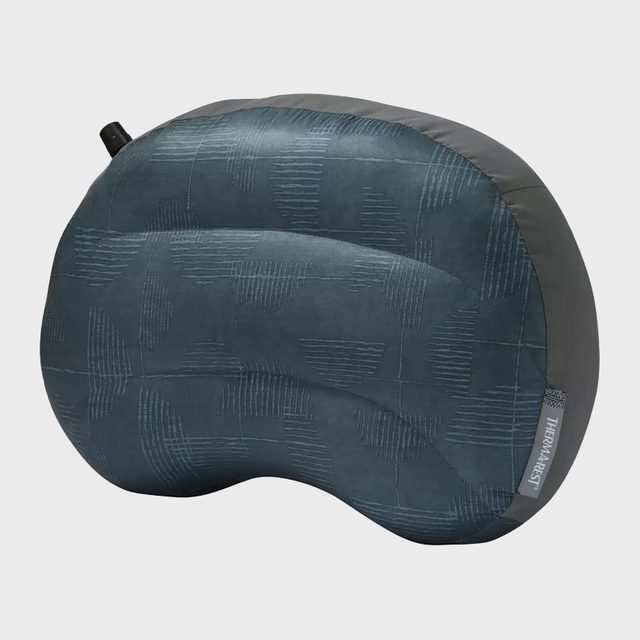 Inflatable pillow features a textured pattern and a valve, resting against a plain background. Text at corner reads: 