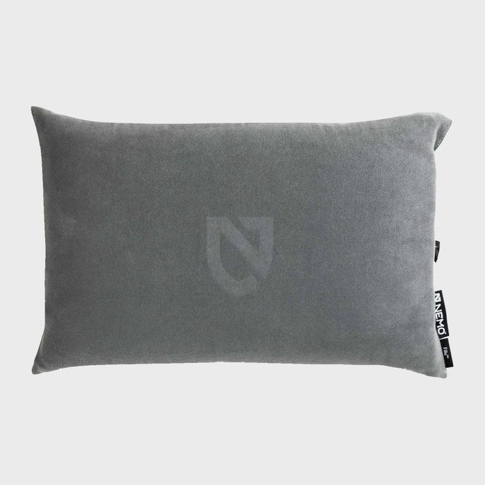 A rectangular gray pillow rests against a neutral background, featuring a subtle logo imprint and a tag labeled 