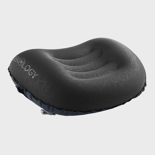 Black inflatable pillow with embossed geometric pattern lies on a plain, light gray background. The word 