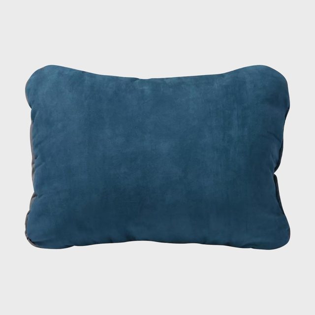 A blue rectangular pillow rests against a plain white background, emphasizing its soft texture and simple design.