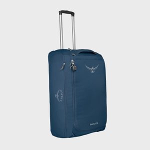 Rolling suitcase stands upright, handle extended, in a studio setting. Navy color with 
