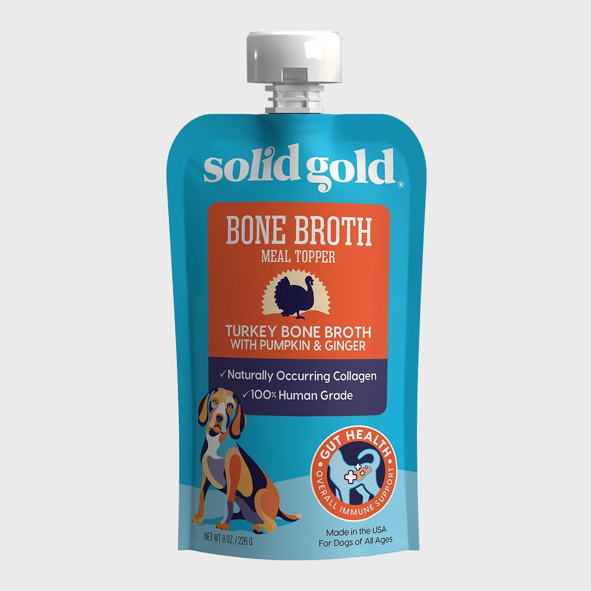 Pouch displays "solid gold" bone broth meal topper for dogs, featuring turkey, pumpkin, ginger. Highlighting gut health, natural collagen, and human-grade quality.