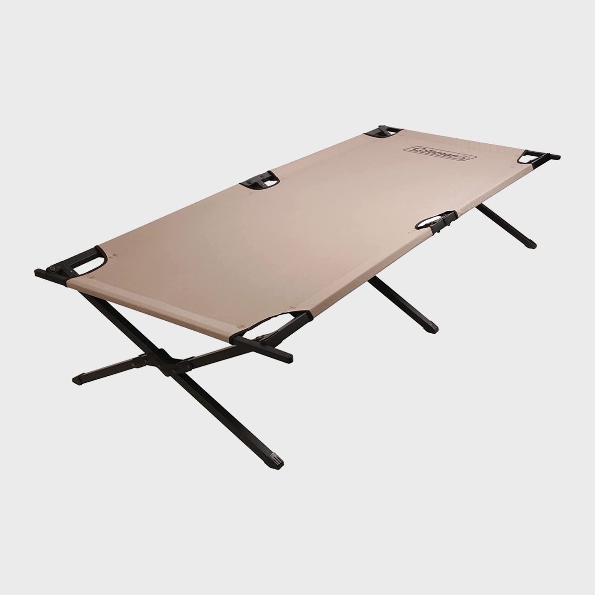 Cot unfolds in a frame with beige fabric, set in a simple indoor environment.