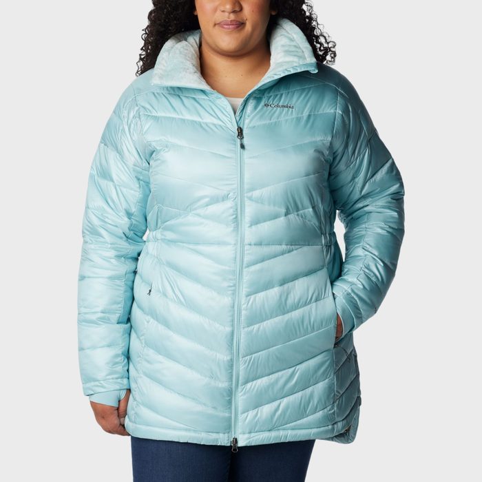 A person wears a light blue puffy jacket with 