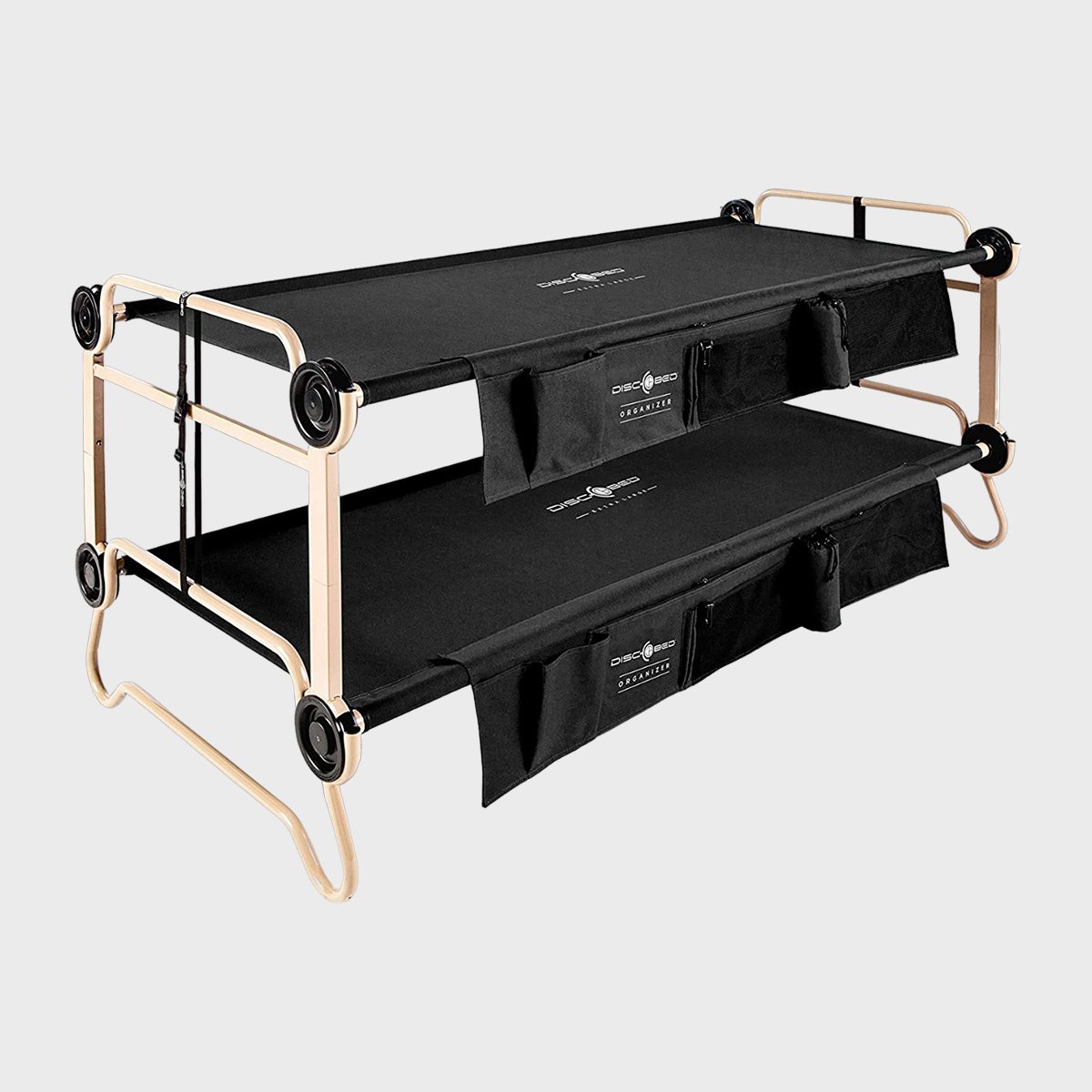 Two-tier collapsible camping cot stacked, featuring tan metal frame with black fabric, in a clean studio setting. Logos "Disc-O-Bed" visible on fabric.