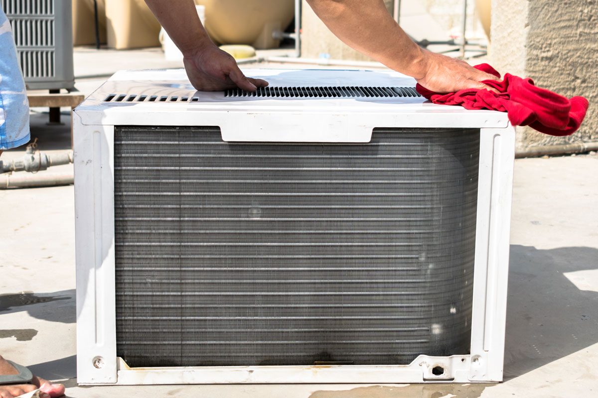Air Conditioning Cooling System Is Being Cleaning and reassembled By A Professional Electrician Man