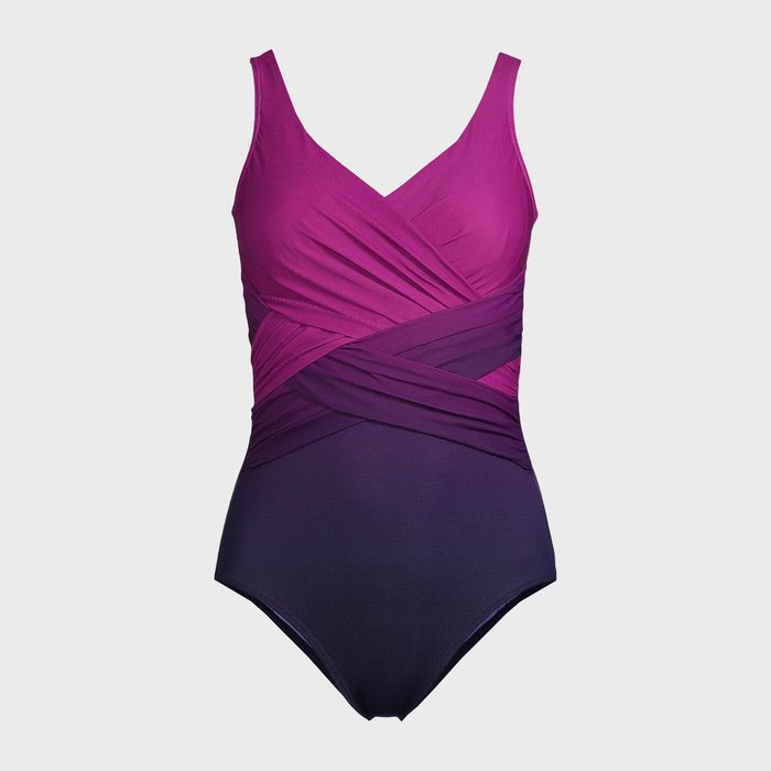 Swimsuit displaying gradient colors from purple to dark blue, featuring crisscrossed fabric, set against a plain white background.