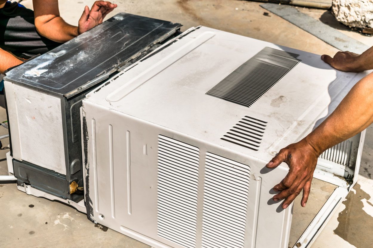 Dusty And Dirty Air Conditioning Cooling System Is Being Cleaning By A Professional Electrician Man