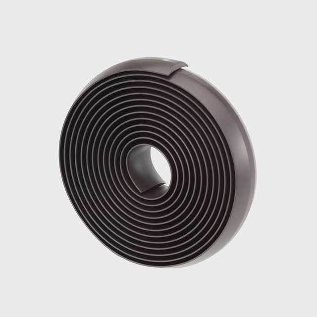 Coiled, layered strip sits upright in a circular form against a plain, light gray background.