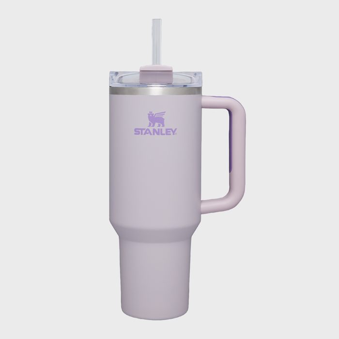 Tumbler stands upright with a straw and handle in a neutral background, branding text 
