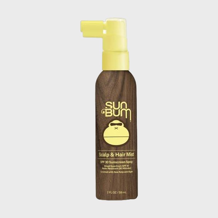 Bottle sprays mist; wood-textured label and yellow logo; sunscreen for scalp and hair. Text: 