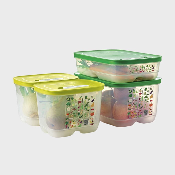 Plastic containers with green lids store fruits and vegetables on a plain background, featuring illustrated produce labels on the sides for identification.
